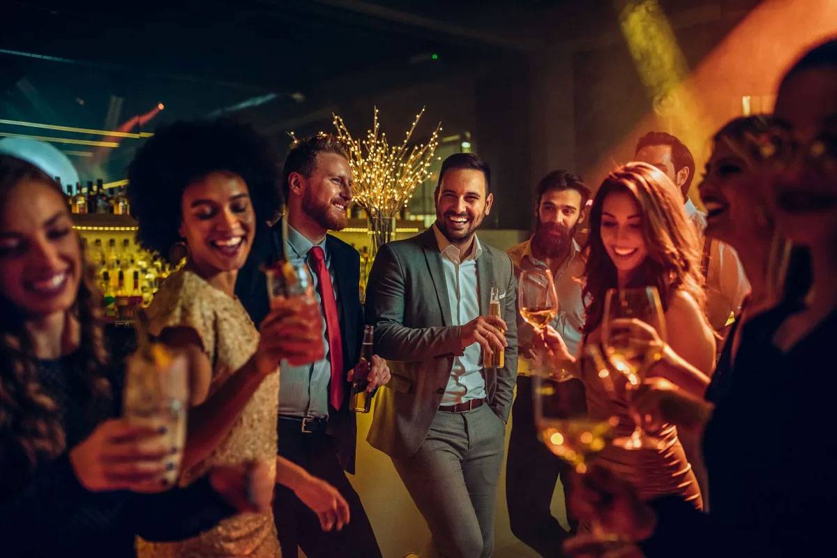A group of adults enjoying cocktails and dancing in Yonkers, NY