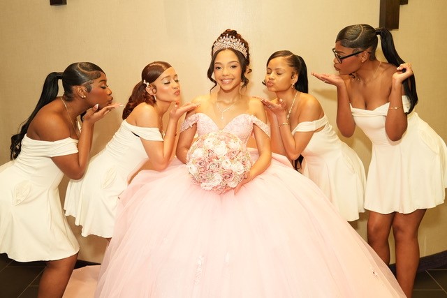 Quinceañera with bridesmaids posing together