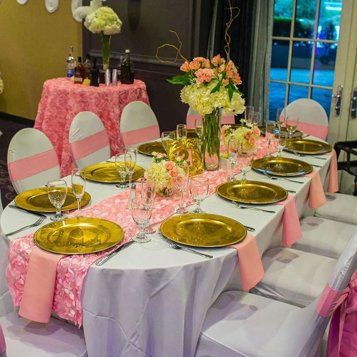 Baby shower table with pink decor, gold plates, and a floral centerpiece in Yonkers, NY