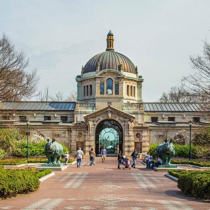 Bronx Zoo entrance with domed architecture, walkway, and animal statues