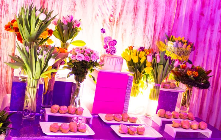 Sweet 16 party with a pink cake, floral arrangements, and colorful treats in Yonkers, NY